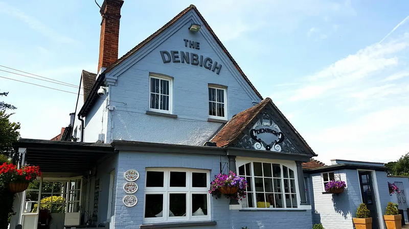 The Front of the Denbigh pub with its distinctive baby blue coloured rendering