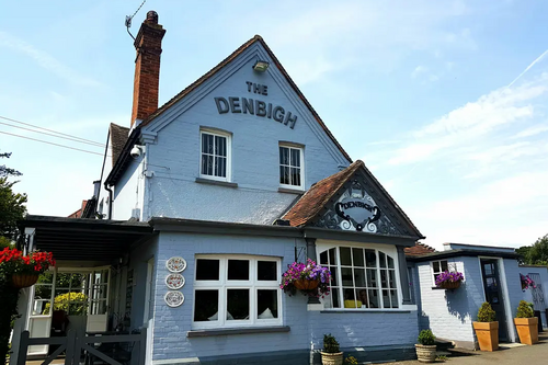 The Front of the Denbigh pub with its distinctive baby blue coloured rendering