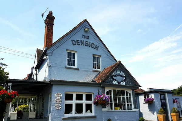 The Front of the Denbigh pub with its distinctive baby blue coloured rendering