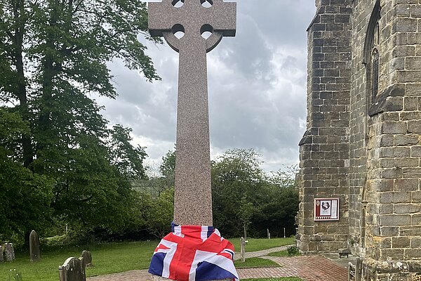 Battle war memorial draped in the Union Jack Flag